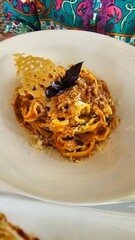 Tripoline bolognese with parmesan cheese and basil