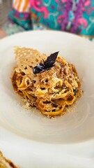 Tripoline bolognese with parmesan cheese and basil
