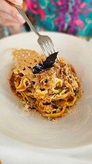 Tripoline bolognese with parmesan cheese and basil