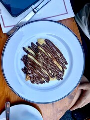 Chocolate crepe served in plate at restaurant