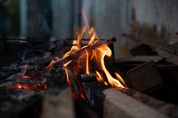 Close-up of a blazing campfire with vibrant orange and red flames at night