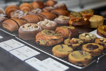 Golden flaky croissants  and  pastry sweets with toppings displayed in a  frech  bakery  at Monaco
Delicious croissants on the store showcase.
