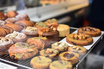 Golden flaky croissants  and  pastry sweets with toppings displayed in a  frech  bakery  at Monaco
Delicious croissants on the store showcase.

