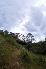 Scenic Arch Bridge in the Mountains of Consacá, Nariño, Colombia – Lush Landscape and River View