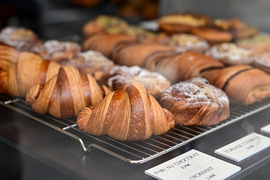 Golden flaky croissants  and  pastry sweets with toppings displayed in a  frech  bakery  at Monaco
Delicious croissants on the store showcase.
