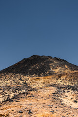 Ash-covered hills in Egypt's Black Desert under a clear sky, scenic and remote landscape. Volcanic