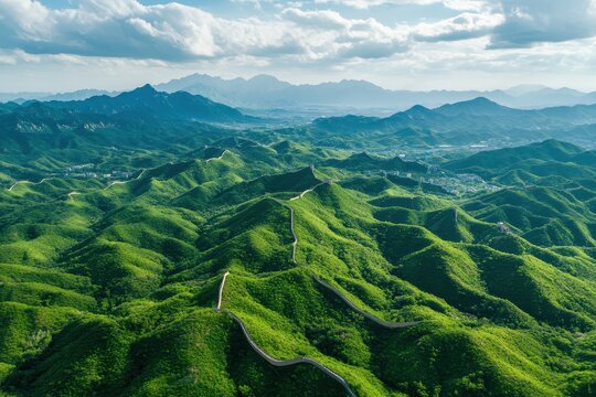 Breathtaking aerial view showcasing the Great Wall of China amidst lush green mountains and blue skies, Rotating aerial view of the Great Wall of China and surrounding green mountains