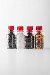 Single-use plastic bottles filled with bulk products on a white background.