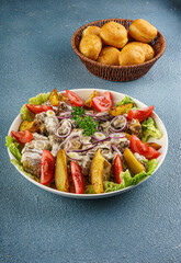Baursaks with Salad of Roasted Potatoes and Mushrooms on Lettuce