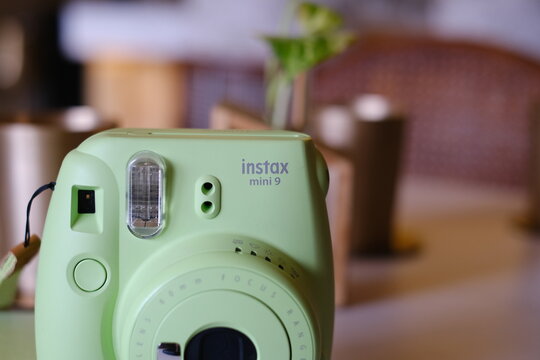 Close-up of FUJIFILM Instax Mini Instant Camera in Mint Green by Fujifilm brand : New Delhi - India: &lrm;June, &lrm;2025