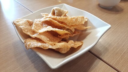 Kerupuk pangsit  goreng or Crispy fried wontons on a plate at restaurant
