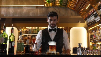 Smart bartender opening mist of whiskey mixed smokey cocktail glass making special drink list presentation for advertisement in focusing alcohol refreshing showcase at luxurious counter bar. Vinosity.