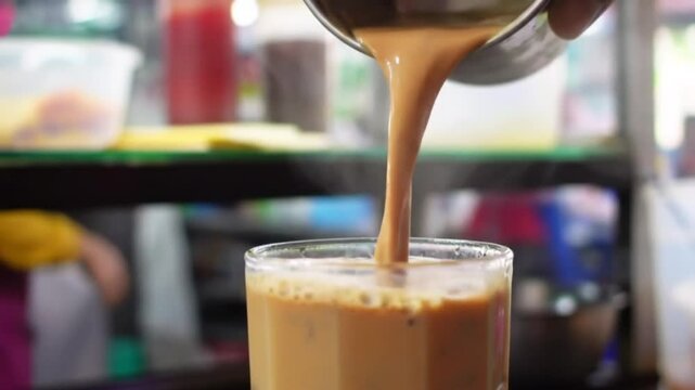 Teh Tarik Chai Brewing Pouring Spiced Tea into Glass