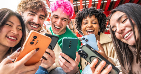 Happy young people having fun watching smart mobile phone device - Technology life style concept
