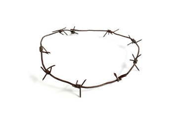 Barbed wire lies on a white background.	