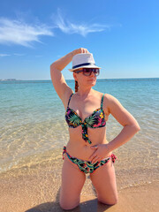 A woman on a clean and modern sandy beach in Doha