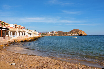 beach in Mazarrón, Spain, with red rocks the beach is characterized by fine golden sand and crystal clear water, town located in the region of Murcia, in the south-east of Spain