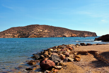 beach in Mazarrón, Spain, with red rocks the beach is characterized by fine golden sand and crystal clear water, town located in the region of Murcia, in the south-east of Spain