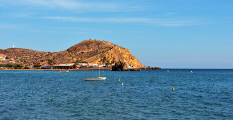 beach in Mazarrón, Spain, with red rocks the beach is characterized by fine golden sand and crystal clear water, town located in the region of Murcia, in the south-east of Spain