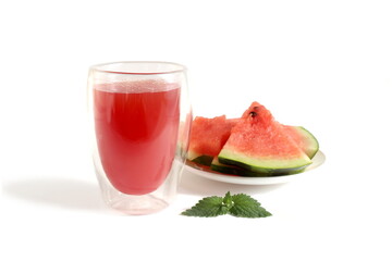 There is a transparent glass with watermelon juice on a white background.	
