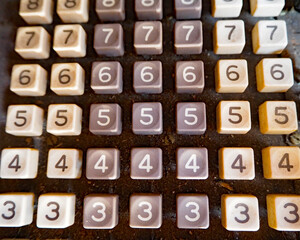 Worn keys form lines and patterns on a vintage adding machine