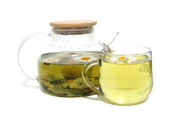On a white background there is a glass teapot and a glass with chamomile infusion.	
