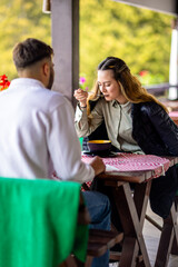 Young couple enjoying meal with nature backdrop