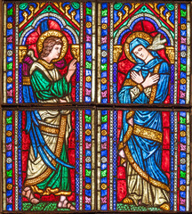 PISTOIA, ITALY - MARCH 16, 2025: The Annunciation on the stained glass of church Chiesa di San Francesco by Franciscus Mossmayer from year 1929.