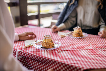 A plate of cream-filled profiteroles elegantly served on the terrace table