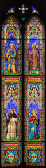 PRATO, ITALY - MARCH 21, 2025: The stained glass with St. Joseph, Andrew Corsini , Vincent and...
