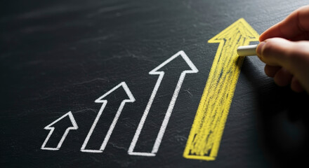 Hand Drawing Upward Yellow Arrow On A Blackboard Representing Business Growth And Success