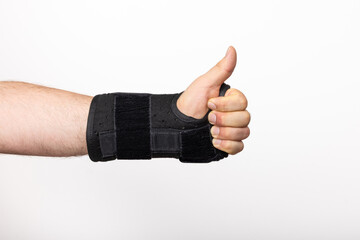 A Wrist Brace For Carpal Tunnel On A Man's Hand Giving A Thumbs-Up