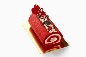 Delicious red velvet roll cake decorated for valentine's day with cream and chocolate hearts