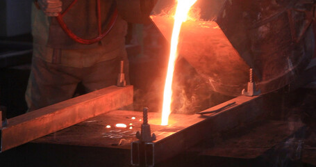 Hard work in the foundry. Pouring molten steel. Liquid steel pouring. Molten metal pouring,...