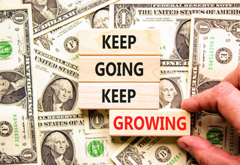 Keep going and growing symbol. Concept words phrase Keep going keep growing on beautiful wooden...