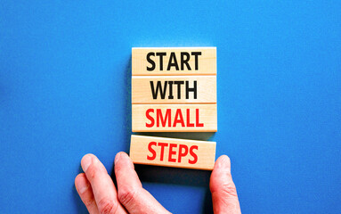 Start with small steps symbol. Concept words phrase Start with small steps on beautiful wooden...