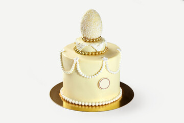 Delicious easter cake decorated with chocolate egg and pearls