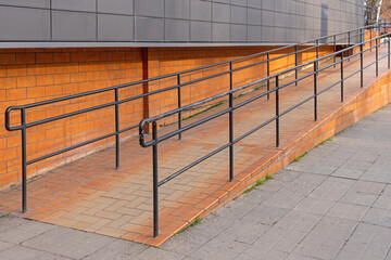 Tiled Ramp for Wheelchair User Access With Metal Fence