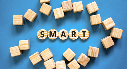 Smart symbol. Concept word Smart on beautiful wooden circles. Beautiful blue table blue background....