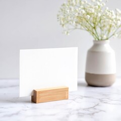 A blank mock up white card in a wooden holder on a minimalist home kitchen background.