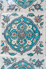 Handmade old Turkish Blue ceramic Tiles on the wall in Istanbul City, Turkey. Close up. Ancient Ottoman patterned Iznik syle design tile composition. Flower patterns on ceramic tiles