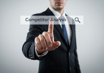 A businessman initiates a competitor analysis search, his finger poised over a digital interface