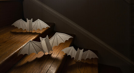 Paper bats on staircase in dark lighting for Halloween decoration  