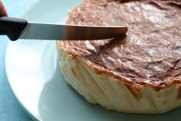 Fototapeta premium San Sebastian cheesecake on plate in restaurant in close-up 