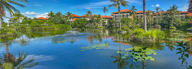 Landscape with Ayodya Resort Bali - Indonesia, featuring a large pond with palm trees and traditional Balinese architecture