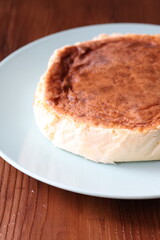 San Sebastian cheesecake on plate in restaurant in close-up	