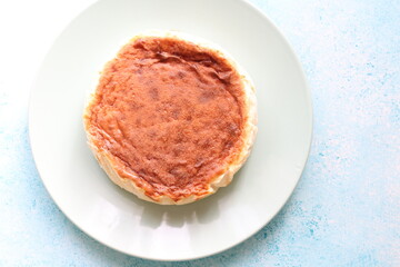 San Sebastian cheesecake on plate in restaurant in close-up	
