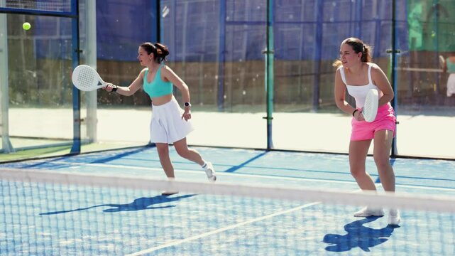 Woman playing with other paddle tennis players. Tennis players participate in a tournament and hit balls to get points