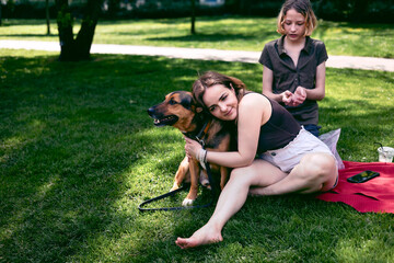Park, mother and boy with dog, smile and sunshine with weekend break, happiness and nature. Family,...