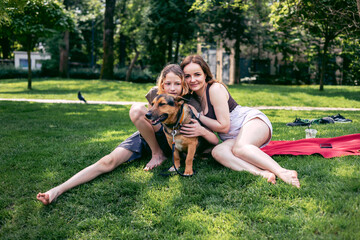 Park, mother and boy with dog, smile and sunshine with weekend break, happiness and nature. Family,...